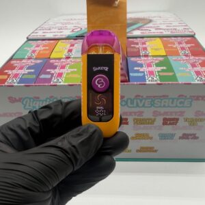 Orange and purple Sweetz Spinners 2g dual flavor disposable vape showing digital LCD screen display