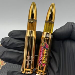 Gold bullet shaped Hollowtips 2g Disposable vape hardware in hand showing Strawberry Staccato label
