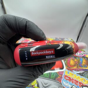 Side view of red Backpackboyz 2g vape device showing LED screen battery indicator and normal mode