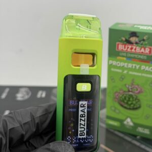 BuzzBar green disposable vape device showing digital battery screen and puff counter