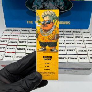 Close-up of a Cook'd Juiced Edition box in the Banana Daddy strain
