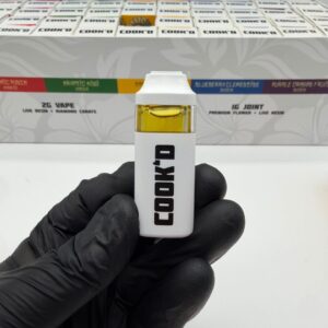 Close-up of the white Cook'd 2G disposable vape device.