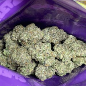 Dense, frosted indoor cannabis nugs inside an open mylar bag from the Sweetz Exotics Box.
